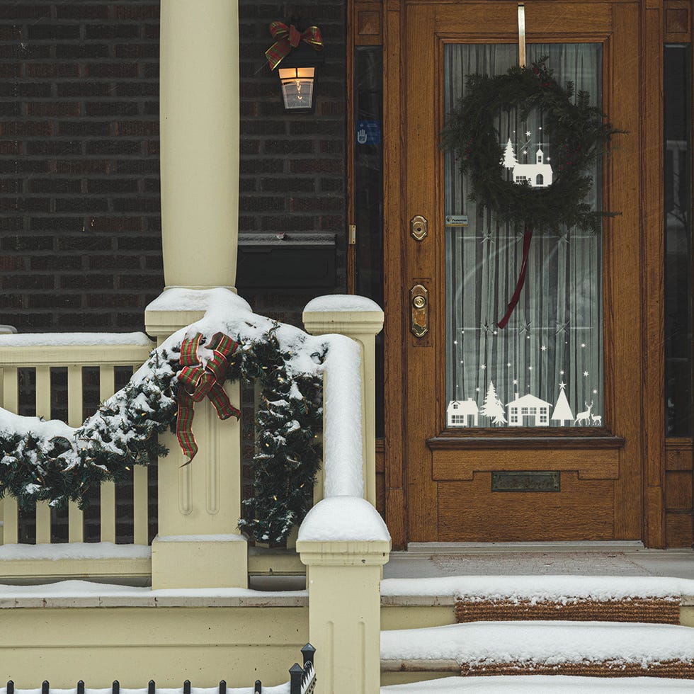 Front porch decorated with Christmas wreath and garland