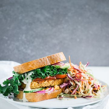 tempeh and kale sandwich with chili coleslaw on table