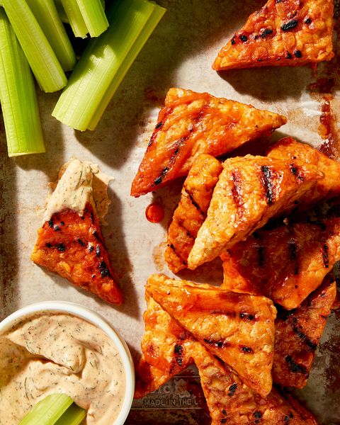 triangle shaped tempeh buffalo wings with a dill chipotle mayo and celery
