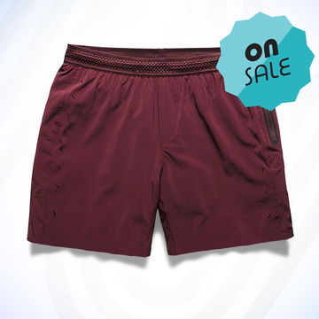 a red pair of session running shorts from ten thousand with a green label
