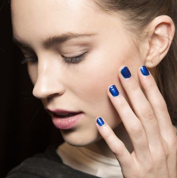 a woman with blue nail polish