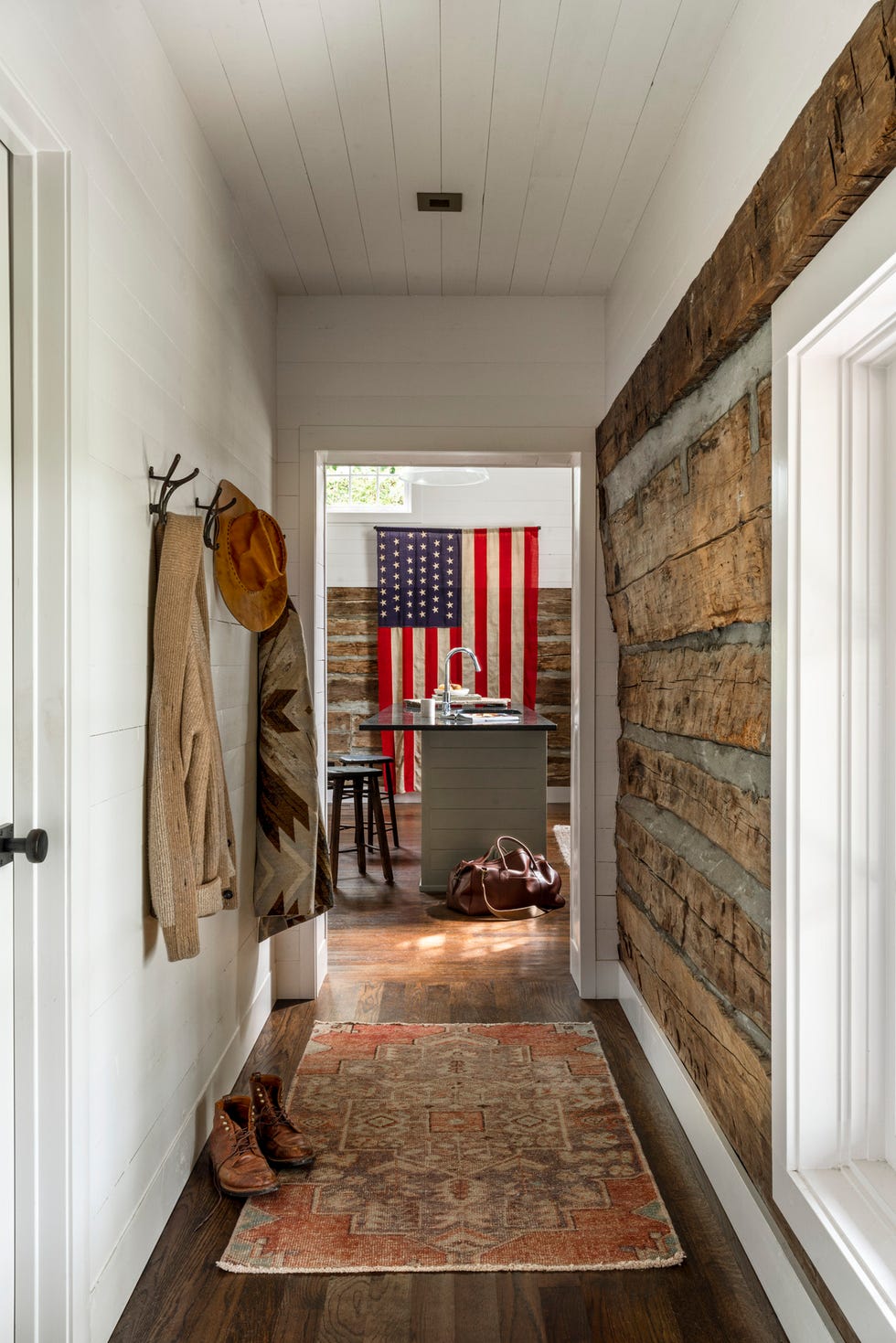 tennessee farm cabin rustic hallway that leads to a room with an american flag