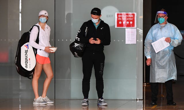 dos tenistas con mascarilla durante la cuarentena previa al open de australia