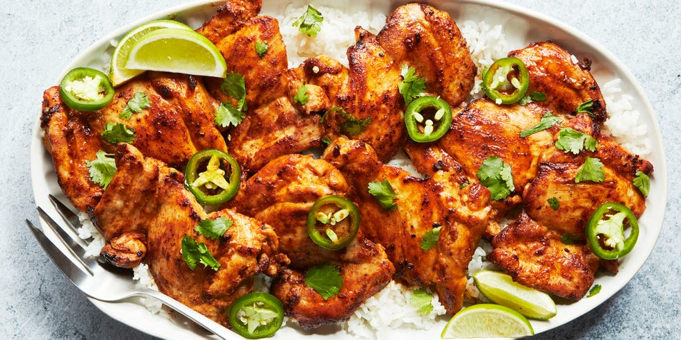 baked chicken thighs with lime wedges and jalapeno slices