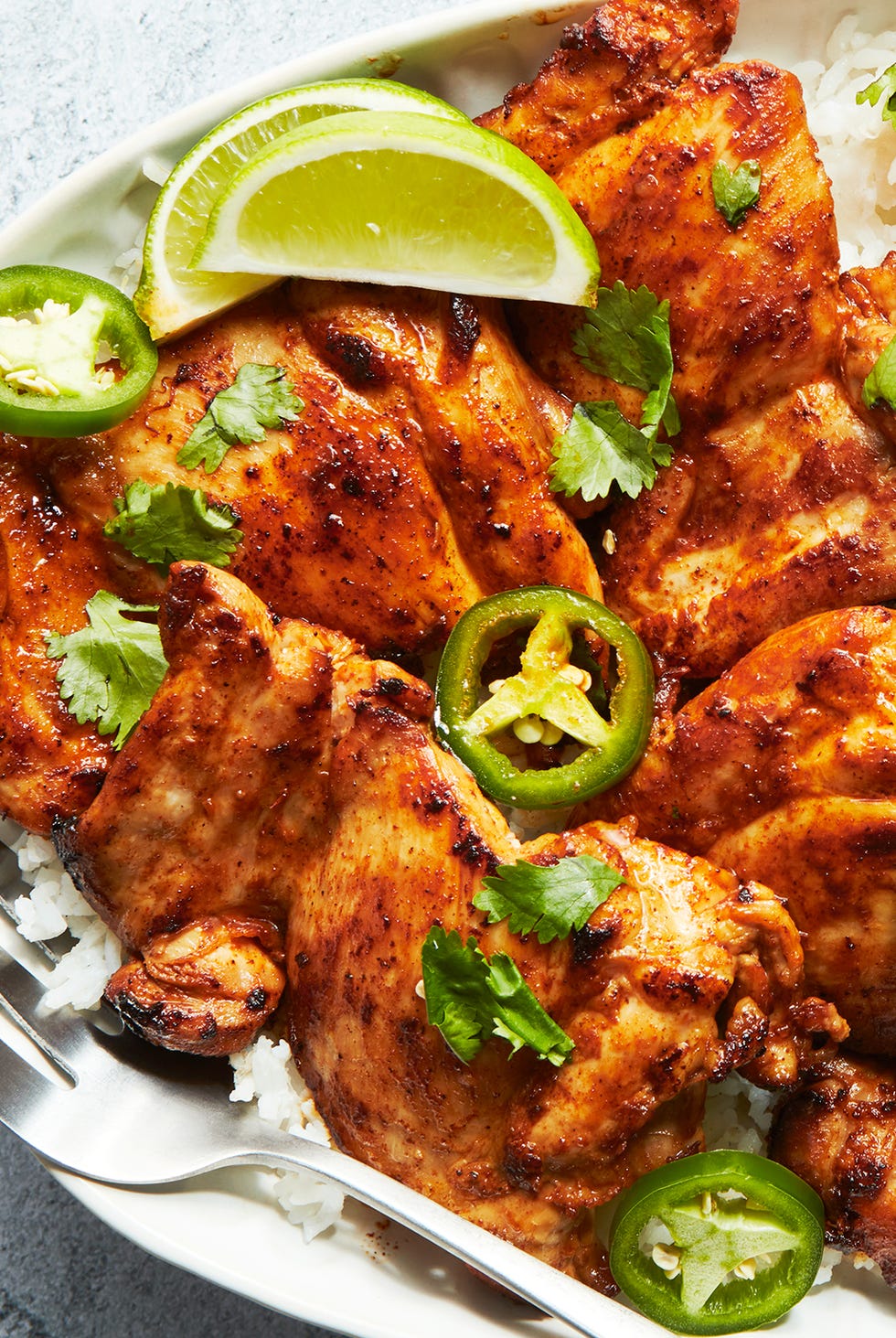 Tequila Lime Chicken Thighs baked chicken thighs with lime wedges and jalapeno slices