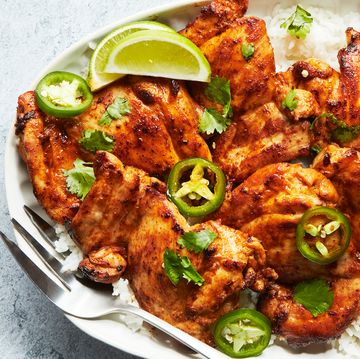 baked chicken thighs with lime wedges and jalapeno slices
