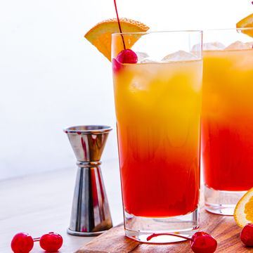 grenadine and orange juice layered tequila cocktail in a glass