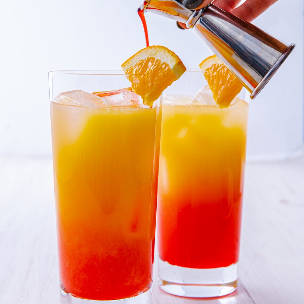 grenadine and orange juice layered tequila cocktail in a glass