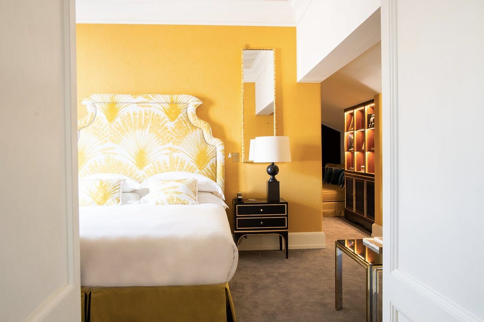 luxurious hotel room with bright decor and modern furnishings