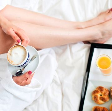 woman in terrycloth robe with breakfast in bed
