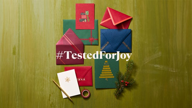 colorful holiday greeting cards and envelopes arranged on a green background with decorative elements