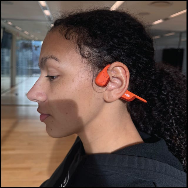 person wearing red bone conduction headphones