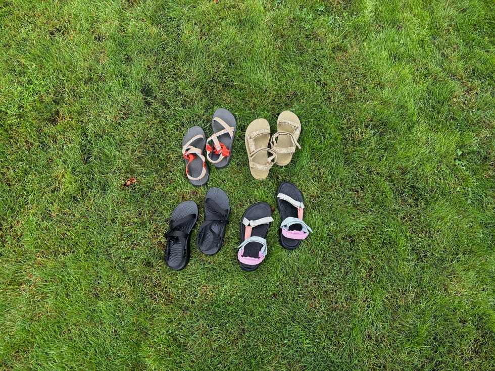 four pairs of teva and chaco sandals