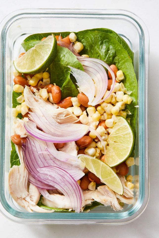 tex mex chicken spring salad with corn and red onion in a glass container