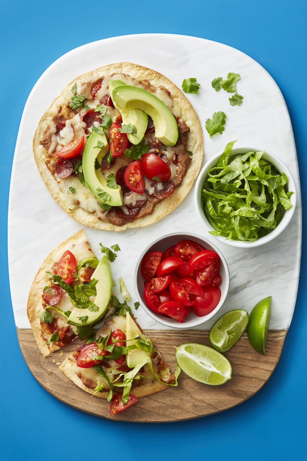tex mex pizzetas on a wood and marble cutting board