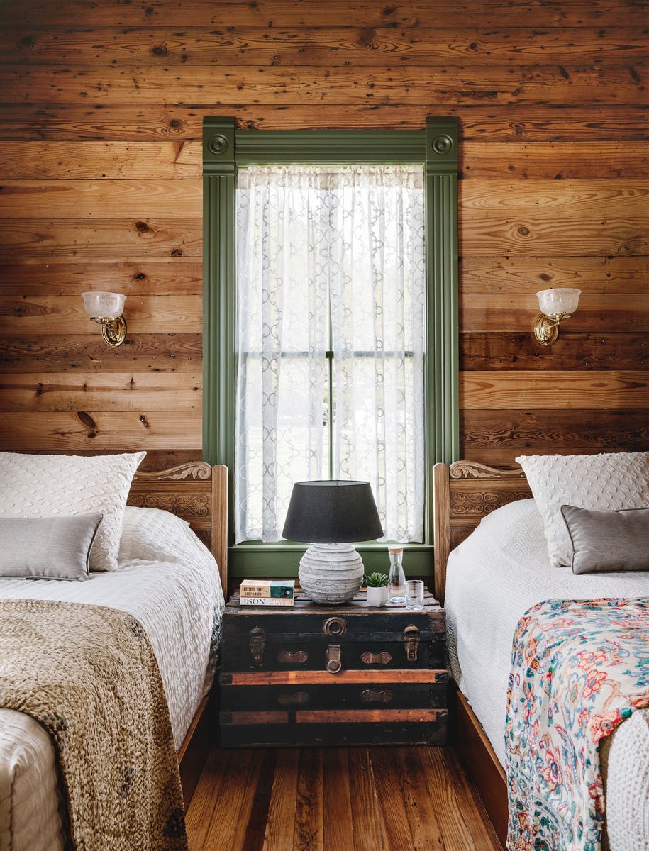 texas guesthouse bungalow bedroom with wood walls and two beds