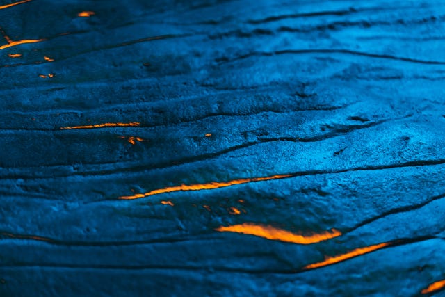 textured metallic colored lava field with hot burning magma