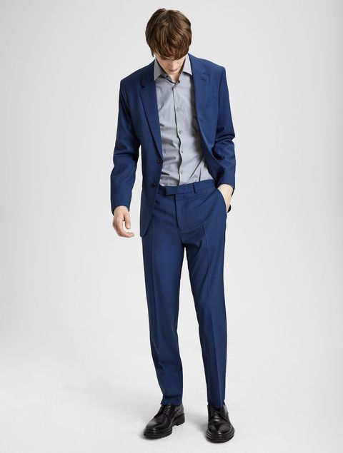 Suit, Clothing, Blue, Standing, Formal wear, Blazer, Outerwear, Jacket, Electric blue, Pocket, 