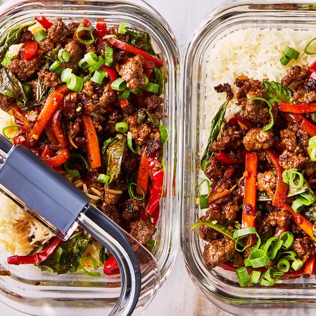 thai inspired basil beef with carrots, bell peppers, and green onion in meal prep containers with rice