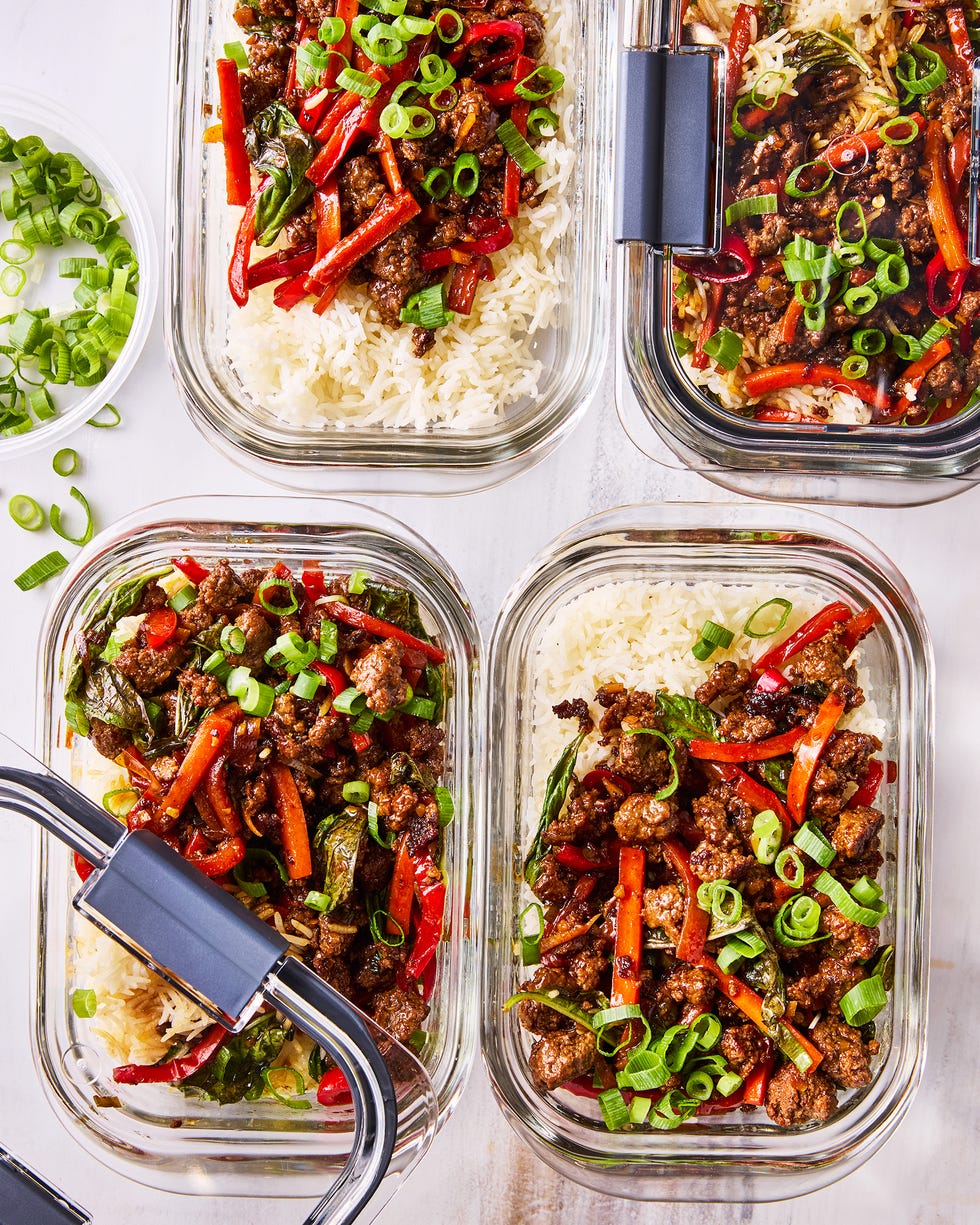 thai inspired basil beef with carrots, bell peppers, and green onion in meal prep containers with rice