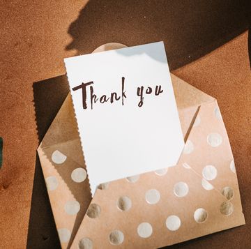 thank you note in gold polka dot envelope with gold pen