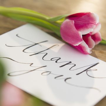 close up of card with thank you in script on front and pink tulip