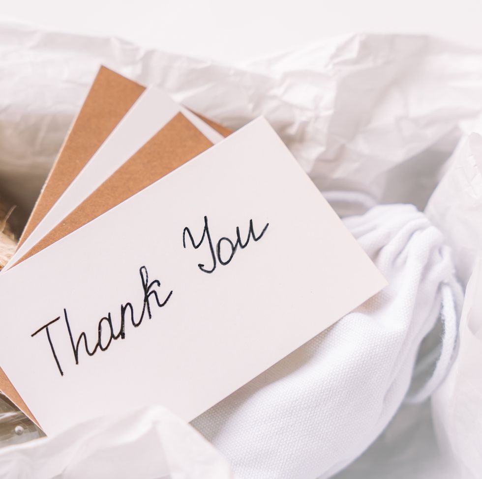 thank you note placed over a jar wrapped in burlap and soft cotton fabric, captured inside a sustainable gift box
