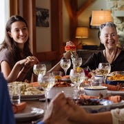 Happy family holding hands during Thanksgiving at home happy family holding hands during thanksgiving at home