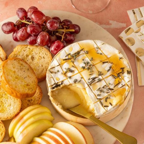 easy baked brie with herbs and honey and grapes on side
