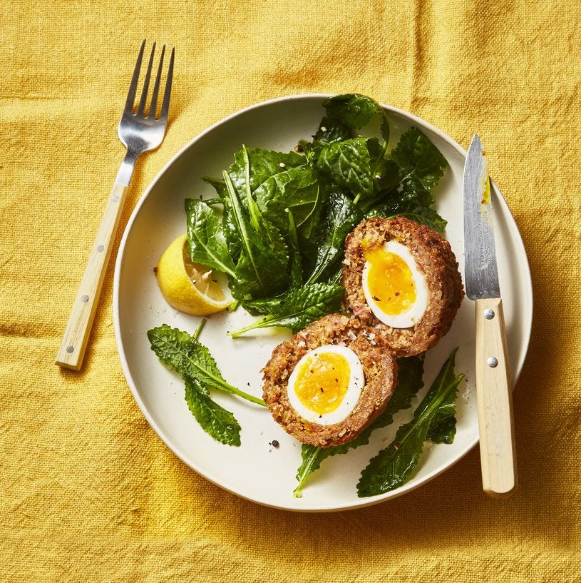 scotch eggs with wilted greens on the side