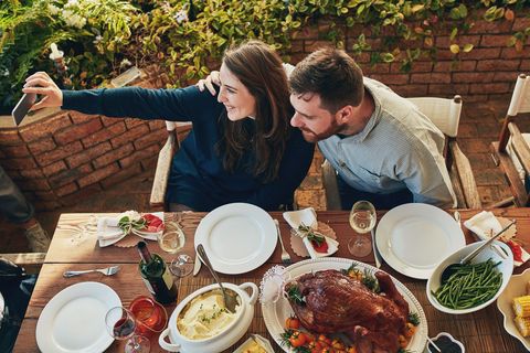 couple taking selfie at thanksgiving dinner