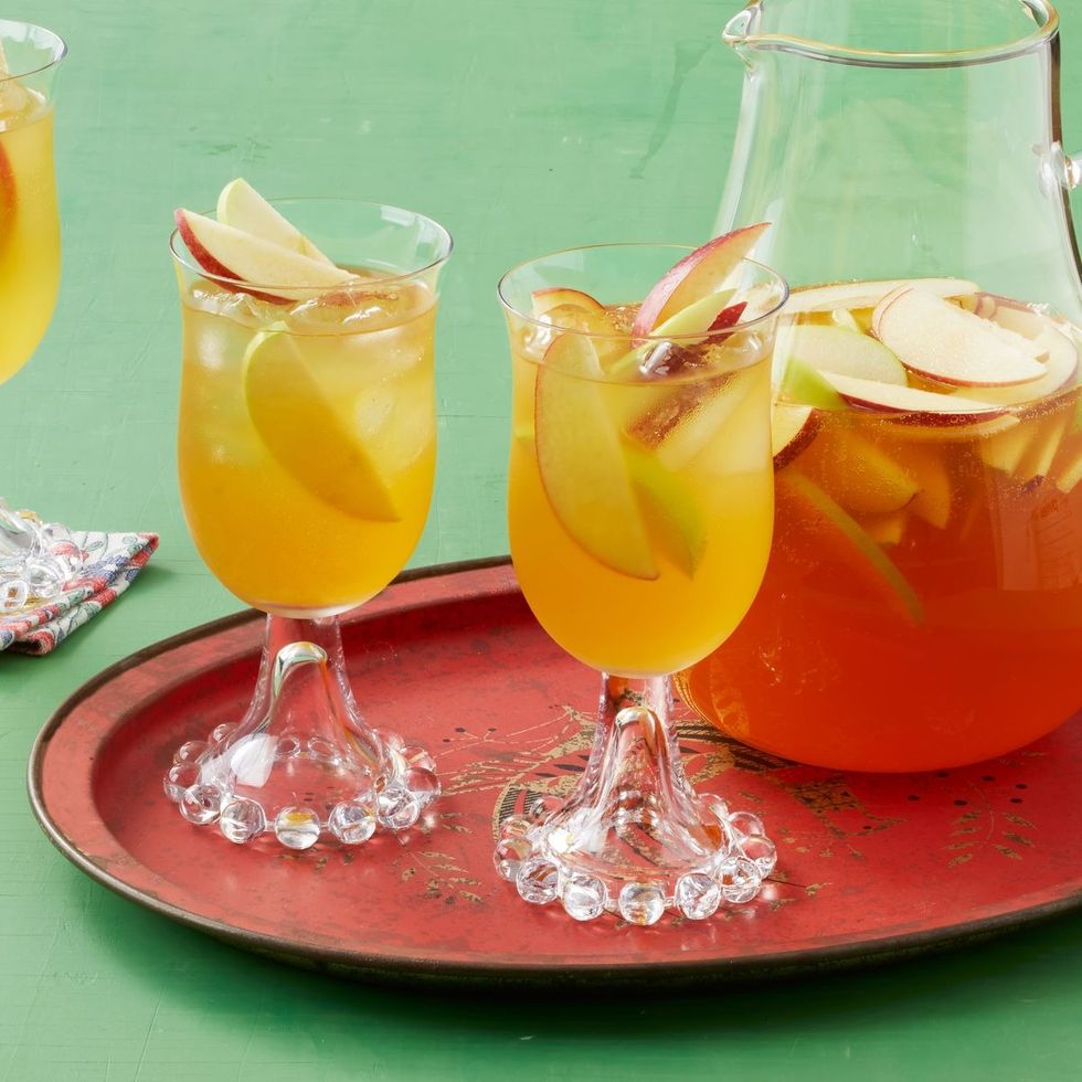 apple cider sangria in wine glasses on red tray