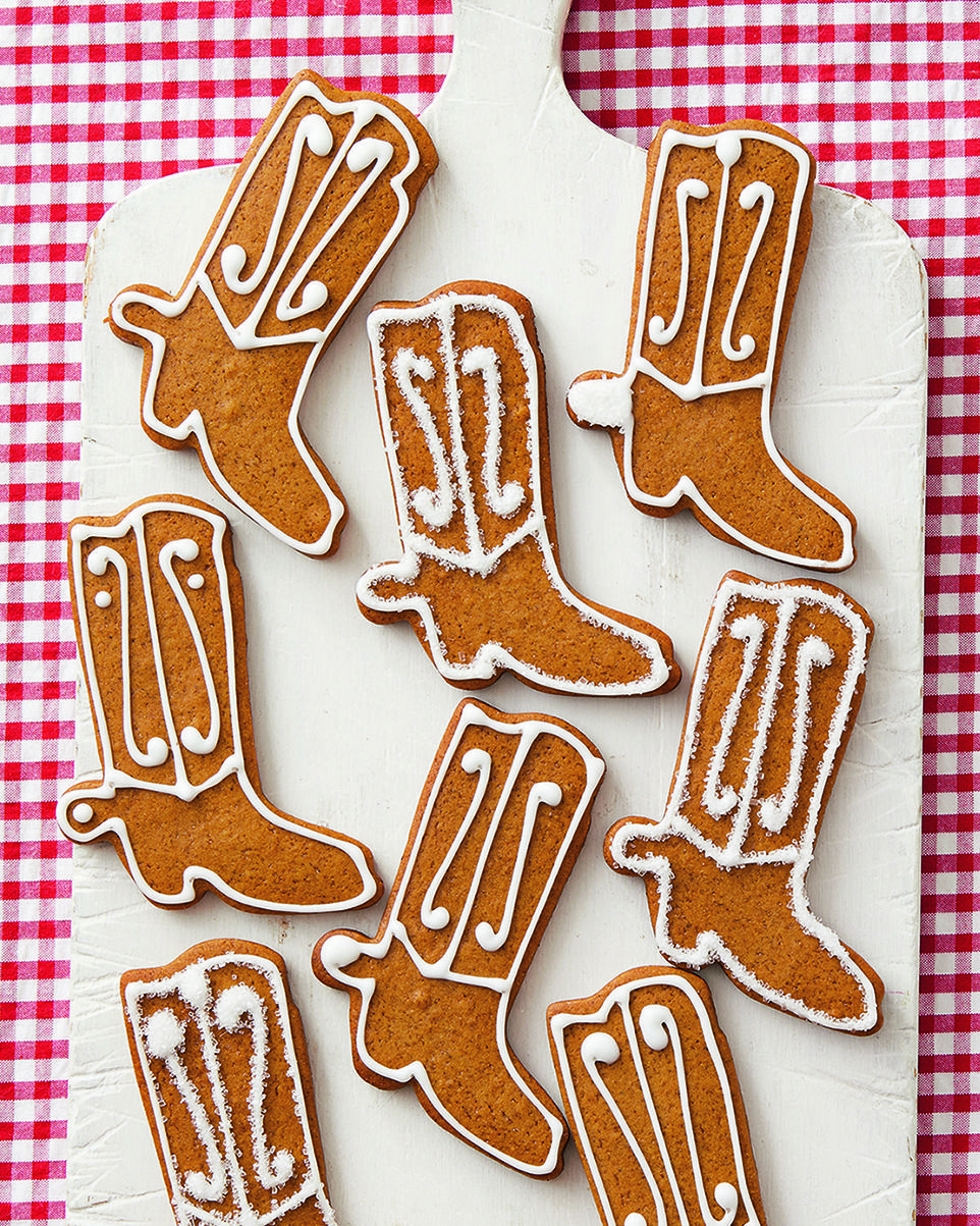 gingerbread cowboy boot cookies on white board