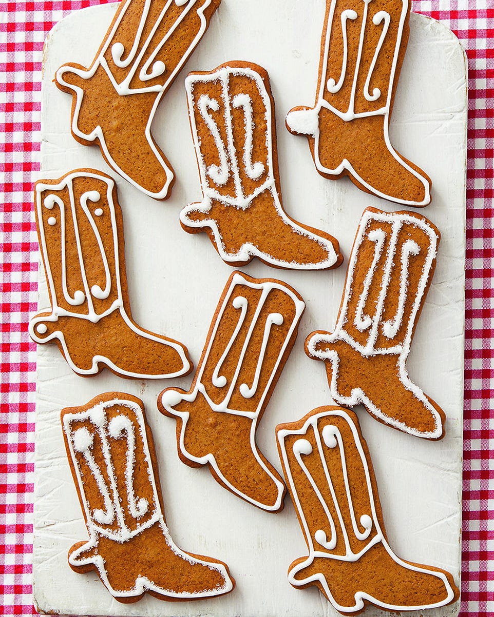 gingerbread cowboy boot cookies on white board