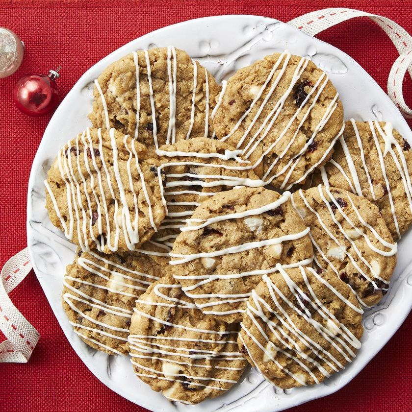 oatmeal slice and bake cookies with white chocolate drizzle on red background