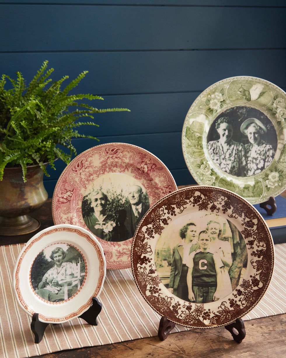 ceramic plates with decorative rims and photos decoupaged into the middle and displayed on plate stands