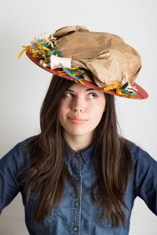 thanksgiving crafts, woman wearing a diy hat with a paper turkey on top