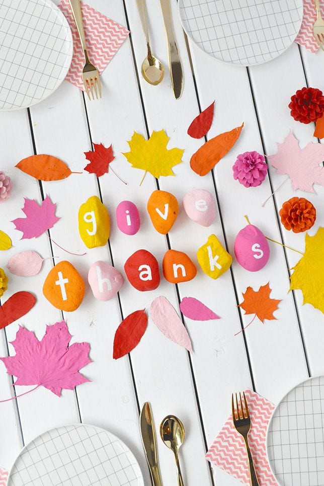 thanksgiving crafts table centerpiece made with rocks that read give thanks