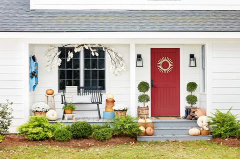 front door and porch decorated for fall