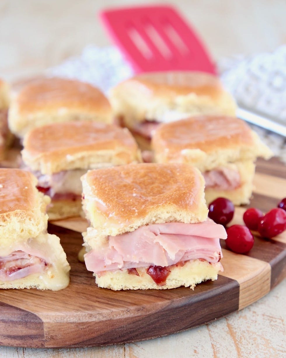 cranberry brie ham sliders on wood board