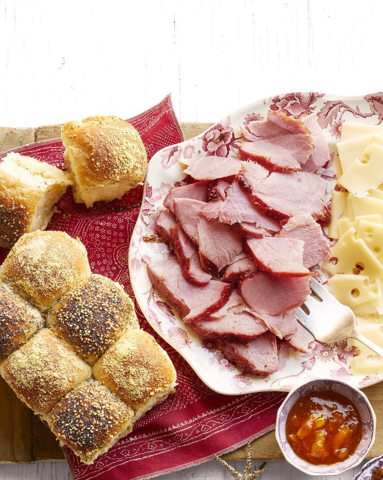 honey glazed ham with checkerboard rolls on platter with cheese slices