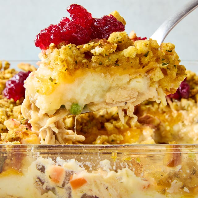 casserole dish layered with mashed potatoes, stuffing, and dolloped with cranberry sauce