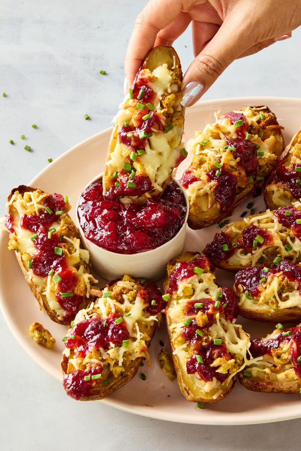 potato skins stuffed with mashed potatoes, stuffing, turkey, and topped with cranberry sauce