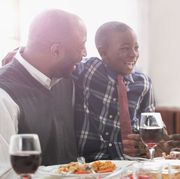 father, son, and grandfather laughing at the thanksgiving table