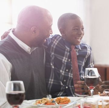 father, son, and grandfather laughing at the thanksgiving table
