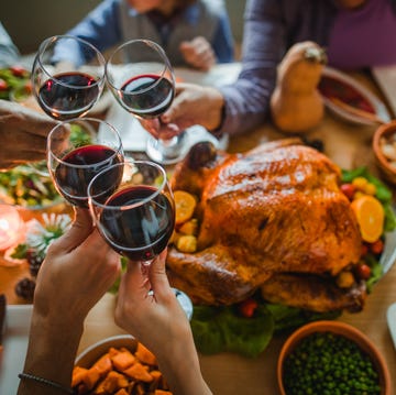 thanksgiving quotes - people toasting with wine during thanksgiving dinner at a dining table people toasting with wine during thanksgiving dinner at a dining table