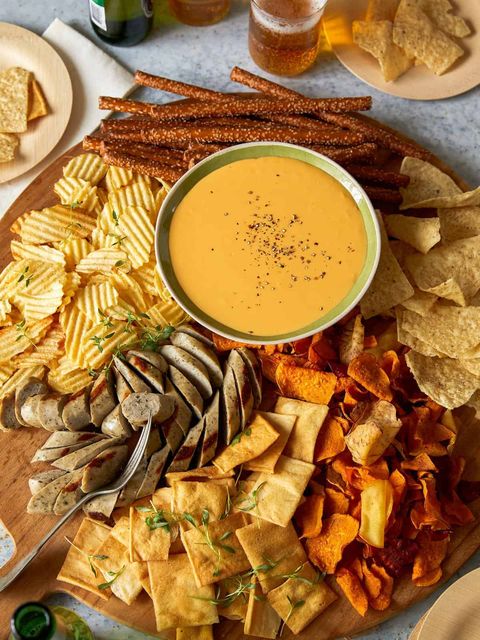 crockpot cheese beer dip on board with chips and sausage