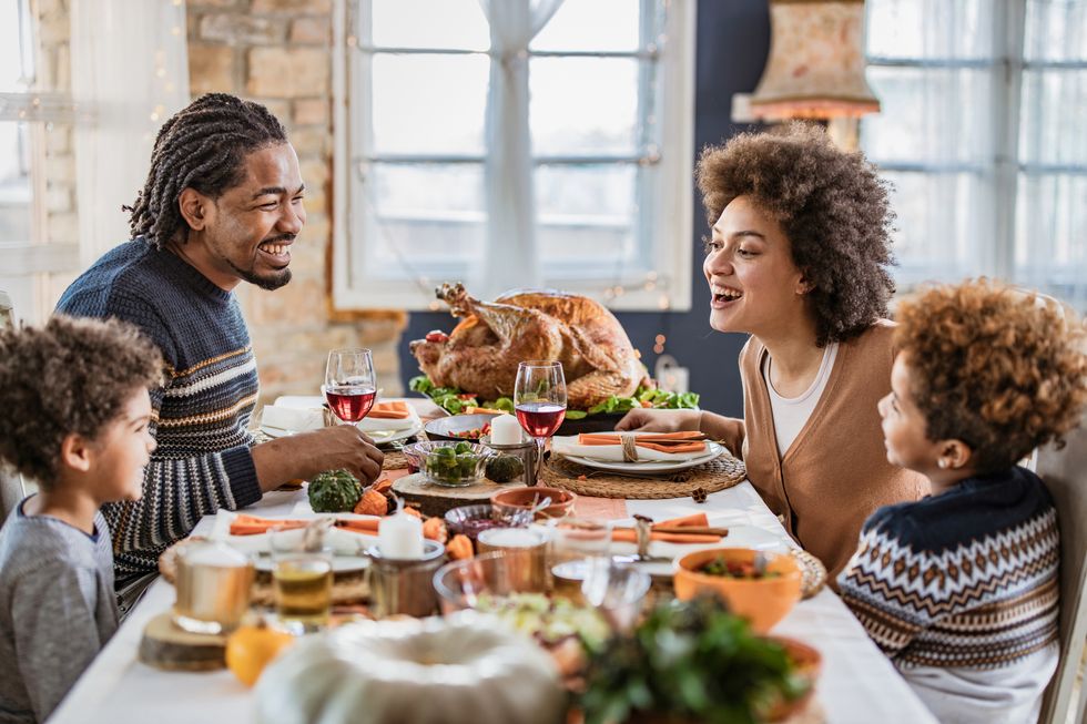 family talking during thanksgiving meal at dining table