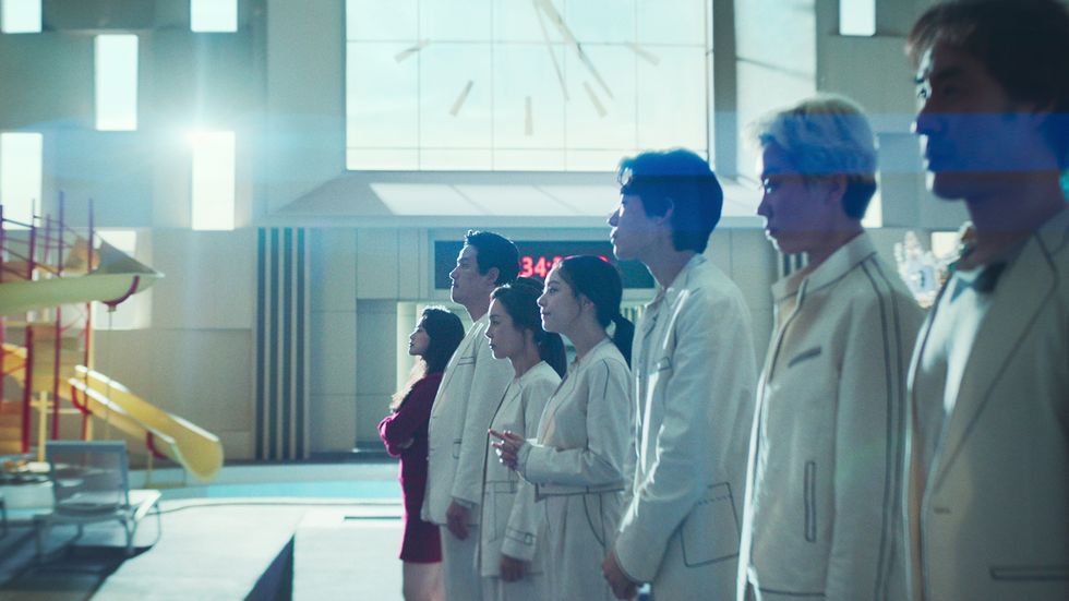 a group of people in white lab coats
