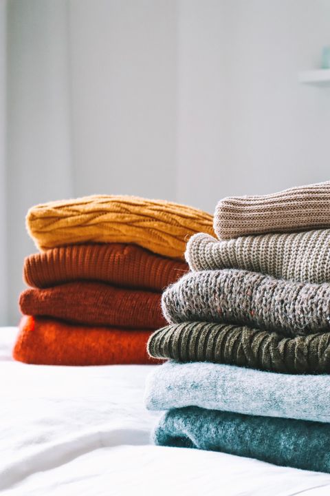closeup of sweaters on bed